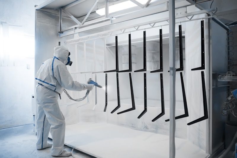 12246373 - worker wearing protective wear performing powder coating